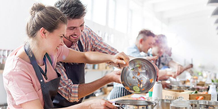 Couple enjoying cooking class in kitchen